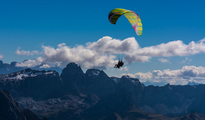 Paraglider flying over mountains
