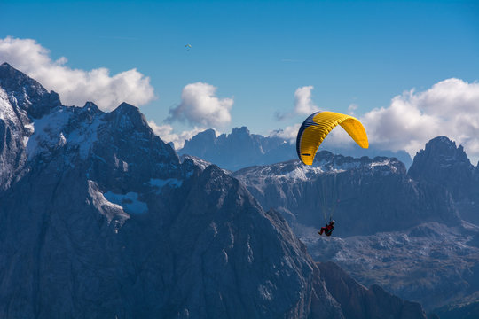 Paraglider flying over mountains
