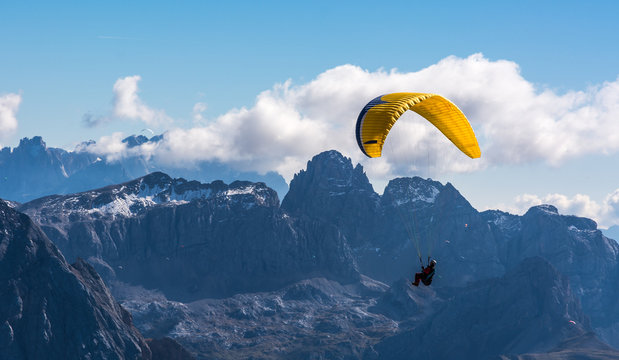 Paraglider flying over mountains
