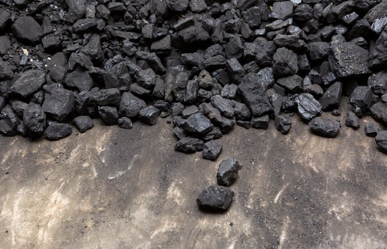 Black coal lying on a pile in house basement