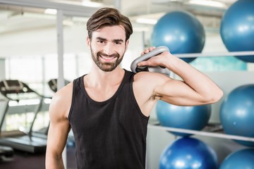 Naklejka premium Concentrated man lifting kettlebell
