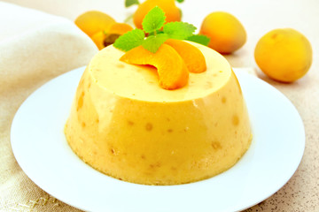 Panna cotta apricot with mint and fruit on table