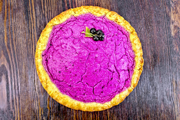 Pie of black currants on dark board top