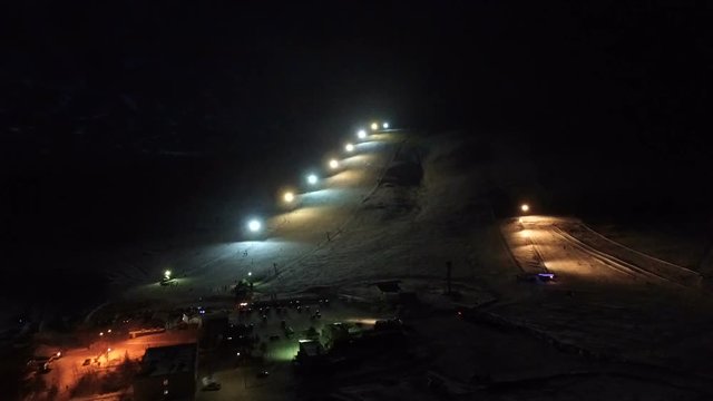 Night flight to the slope of the ski resort.