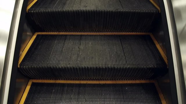 The work of the escalator in the mall, the stairs are moving up
