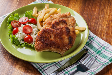 Cutlet Cordon Bleu with pork loin served with French fries and salad