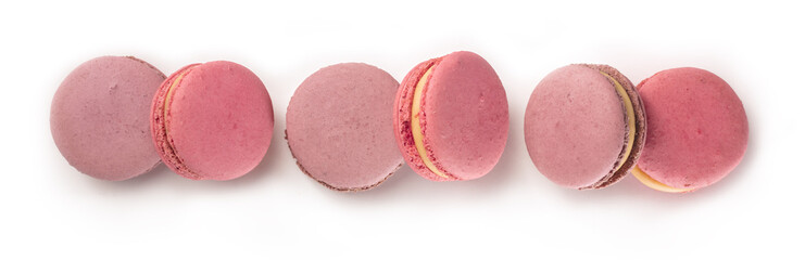 Pastel coloured macarons forming a row on white