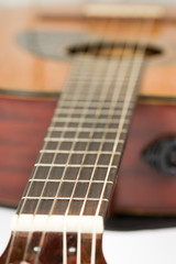 Fototapeta premium Acoustic guitar neck with frets with blurred background