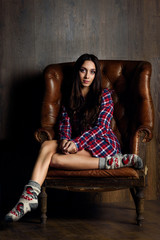 woman with long black hair posing on the armchair