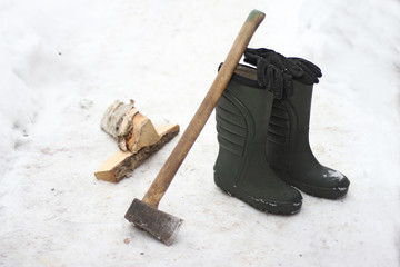 pair of boots, gloves, axe and firewood