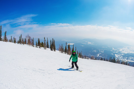 Young successful man snowboarding in the mountains Sheregesh