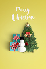 merry christmas and chirstmas tree on color background