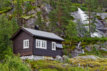 Fototapeta na wymiar Traditional norwegian wooden house with solar panels in Norway mountains