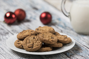Cookies and Milk for Santa / Cookies and milk with Christmas decoration on a wooden background