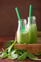 healthy green spinach smoothie with lemon orange