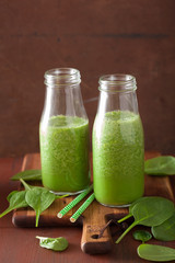 healthy green spinach smoothie with lemon orange