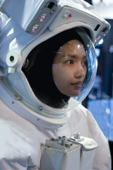 Asian woman in a suit astronaut