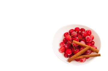 frozen cherries in a white bowl on a white background.
