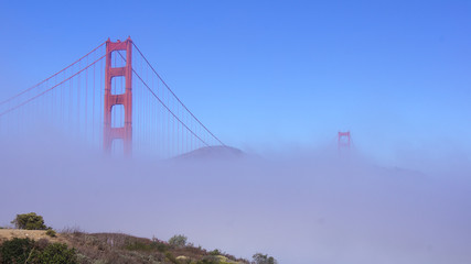 SAN FRANCISCO, USA - OCTOBER 5th, 2014: Golden Gate Bridge with heavy mist or fog as seen from Fort Point- © miles_around