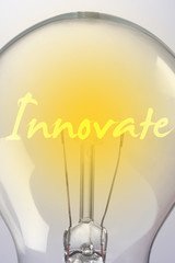 "Innovate" words shining on filament bulb - idea and business concept
