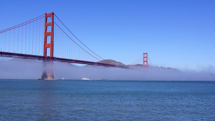 Fototapeta premium SAN FRANCISCO, USA - OCTOBER 5th, 2014: Golden Gate Bridge with heavy mist or fog as seen from Fort Point-