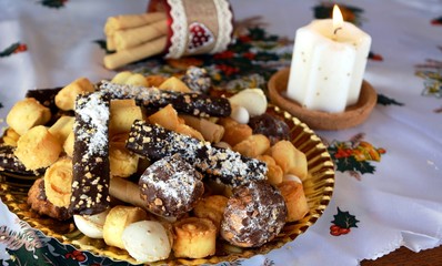 Lovely close up image of Christmas cookies decorated on a table with lighted candle