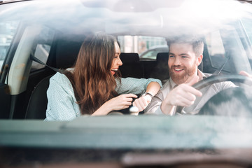 Couple laughs in car