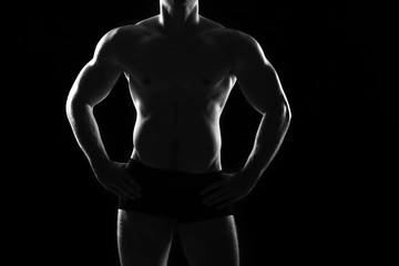 Fototapeta premium Beautiful and muscular black man's back in dark background