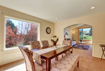 Spacious dining room interior with upholstered bench