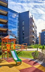 Modern complex of residential buildings and children playground