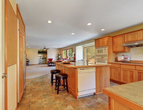 Kitchen interior with honey cabinets and white built-in appliances
