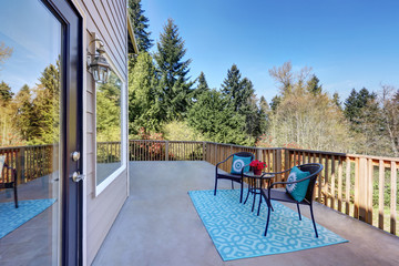 View of second floor deck finished with wooden railings.