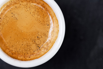 Cup of hot espresso coffee on wood table