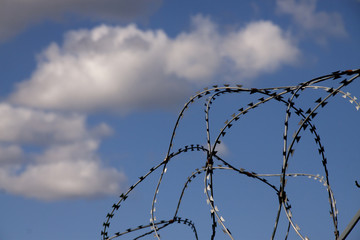 Barbed wire in a blue sky