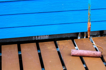 Painting of blue wall with paint roller