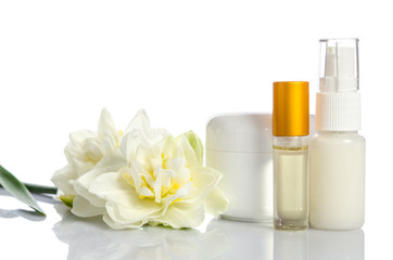 Fototapeta na wymiar cosmetics with flowers isolated on white background