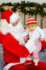 little baby in the arms of Santa Claus