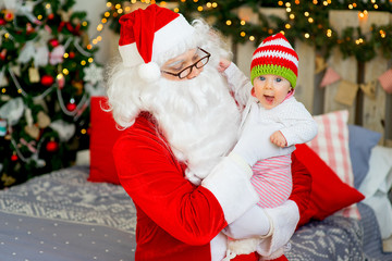 little baby in the arms of Santa Claus