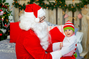 little baby in the arms of Santa Claus