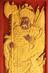 Beautiful Golden God of warrior emperor on wooden door skin texture at Chinese Shrine.
 - public place of worship, Thailand.
