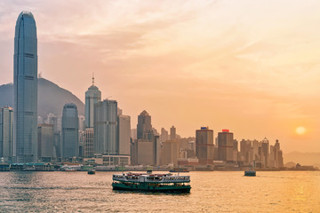 Star ferry at Victoria Harbor of Hong Kong at sunset