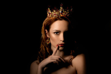 Beautiful girl with a golden crown and professional make-up