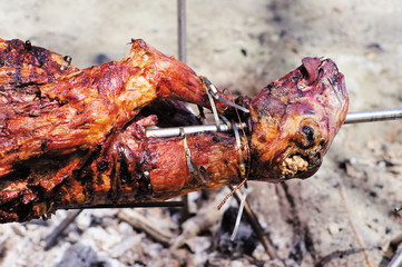 Lamb head roasted on the stick flame