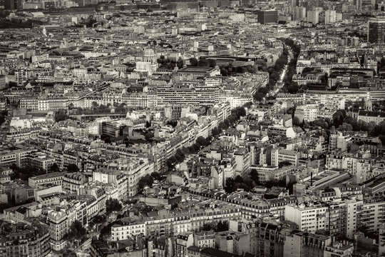 Aerial view of Paris, France at night. Traffic lights in the city after sunset. Black and White photo.