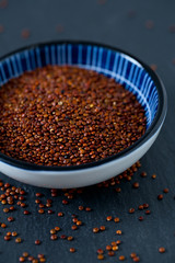 red quinoa on dark background