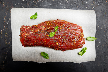 marinated fillet of veal meat on paper for baking.Top view.