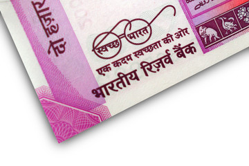 Obraz premium Closeup of new Indian Currency note new INR 2000 banknote with swatch bharat programme making clean India and eye glasses of Mahatma Gandhi