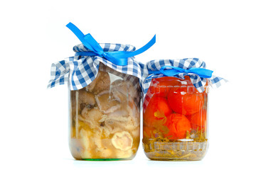Canned vegetables in glass jars isolated on white background