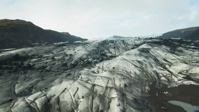 View of Solheimajokull glacier covered with black volcanic ash in Iceland

