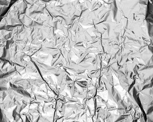 silver leaf foil background with shiny crumpled uneven surface f